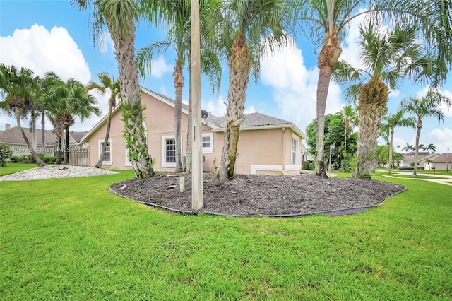 rear view of property with a lawn