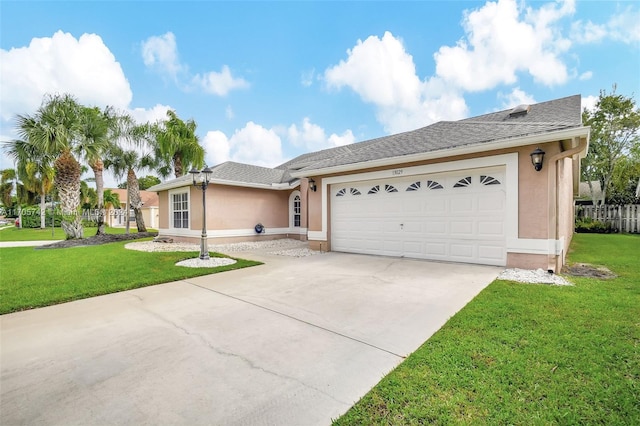 ranch-style house featuring a front yard and a garage