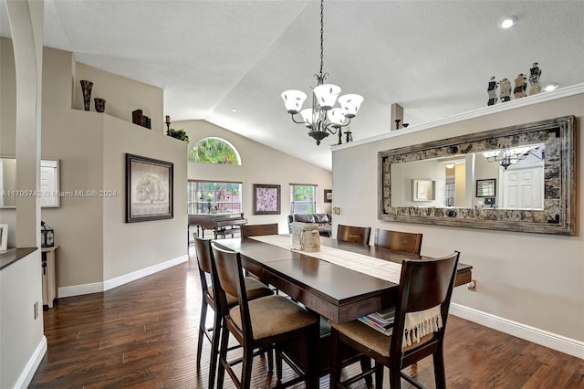 dining room with a textured ceiling, dark hardwood / wood-style floors, and vaulted ceiling