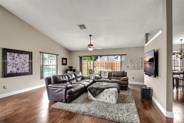 living room featuring a textured ceiling, plenty of natural light, and dark wood-type flooring