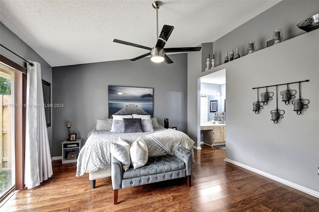 bedroom with vaulted ceiling, hardwood / wood-style flooring, ceiling fan, a textured ceiling, and connected bathroom