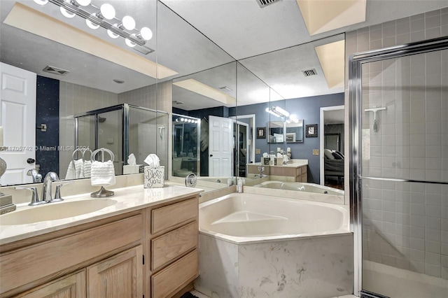 bathroom featuring vanity and independent shower and bath