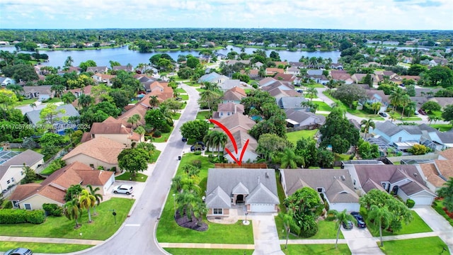 birds eye view of property with a water view