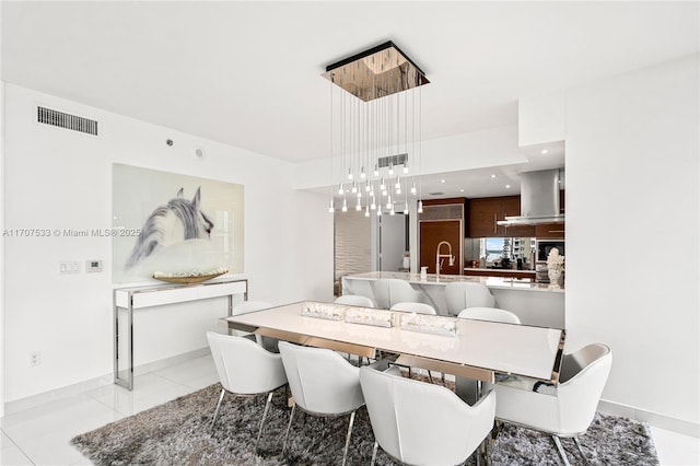 dining space featuring light tile patterned floors and sink