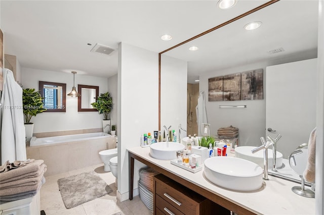 bathroom with vanity, a bidet, tile patterned floors, a relaxing tiled tub, and toilet