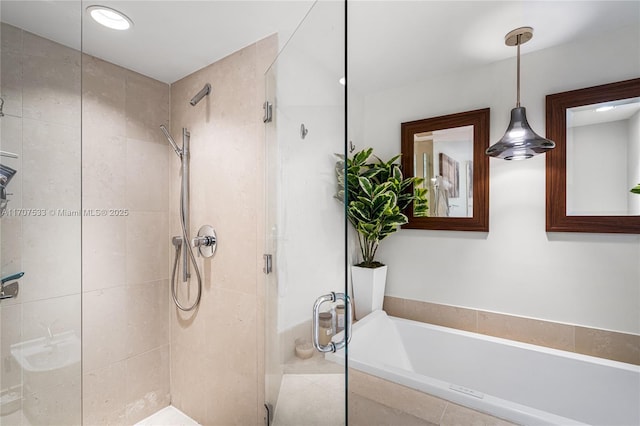 bathroom featuring separate shower and tub