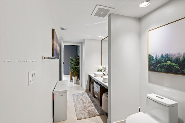 bathroom featuring tile patterned flooring, vanity, and toilet