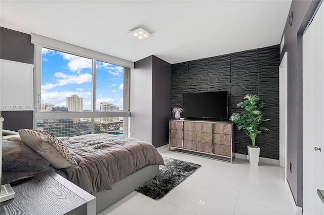 tiled bedroom with a wall of windows