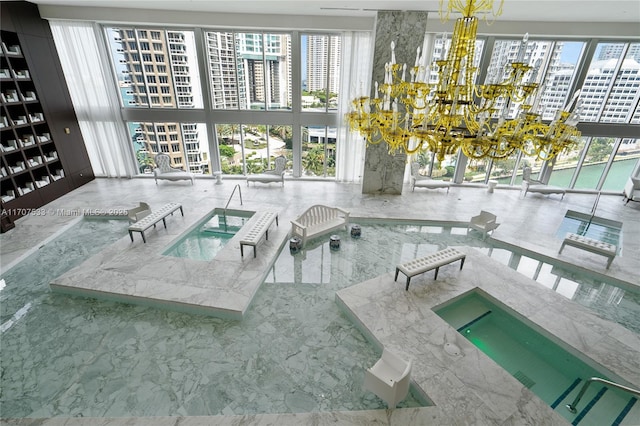 view of swimming pool with an indoor hot tub