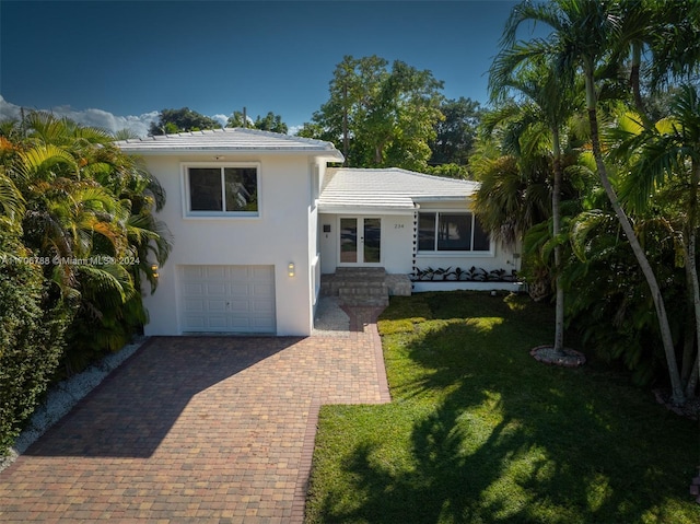 view of front of property featuring a garage and a front yard