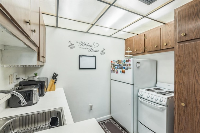 kitchen featuring sink and white appliances