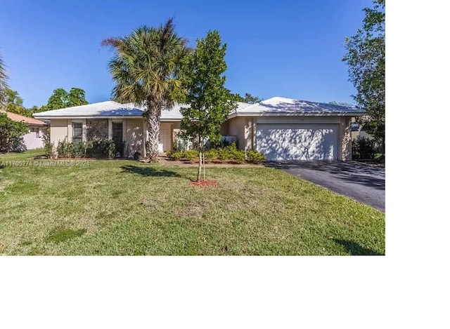 ranch-style house with a front yard and a garage