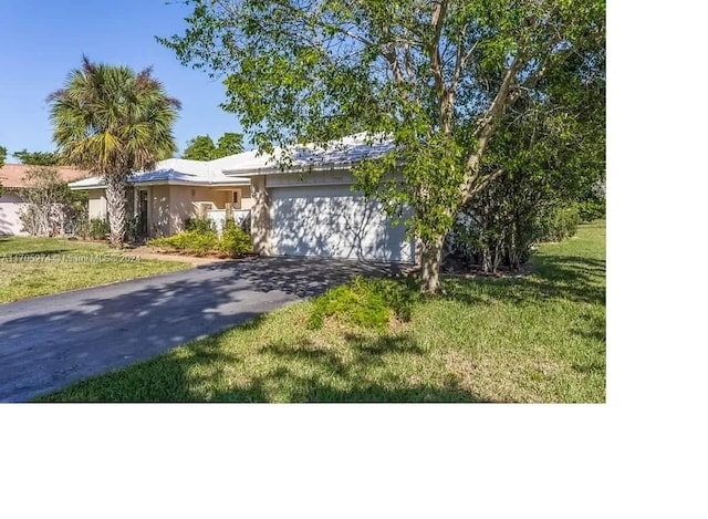 view of front of house with a garage and a front yard