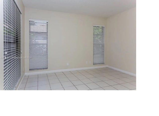 unfurnished room with light tile patterned floors