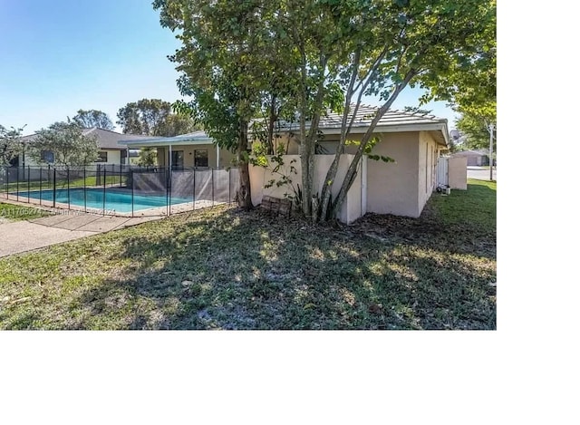 view of yard with a patio area and a fenced in pool