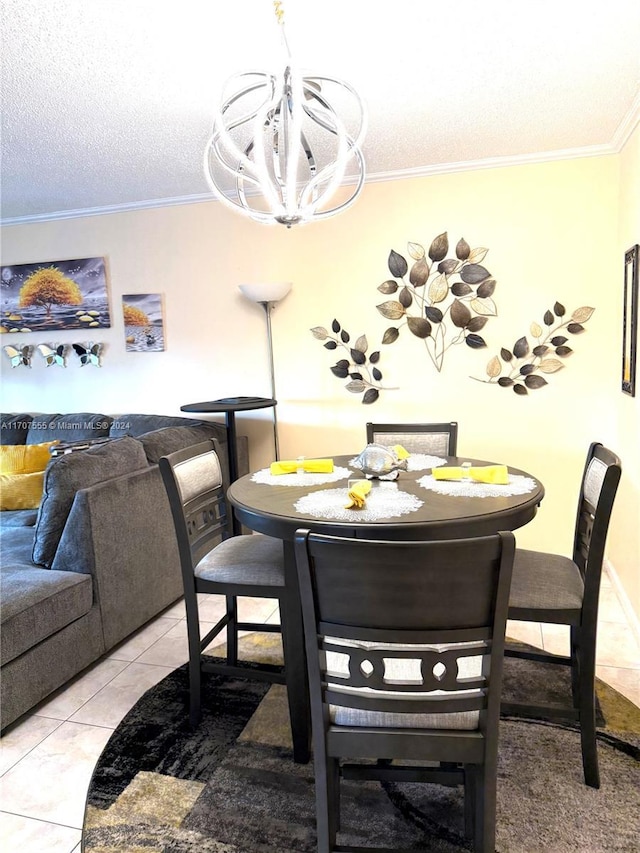 dining room with light tile patterned floors, ornamental molding, a textured ceiling, and an inviting chandelier