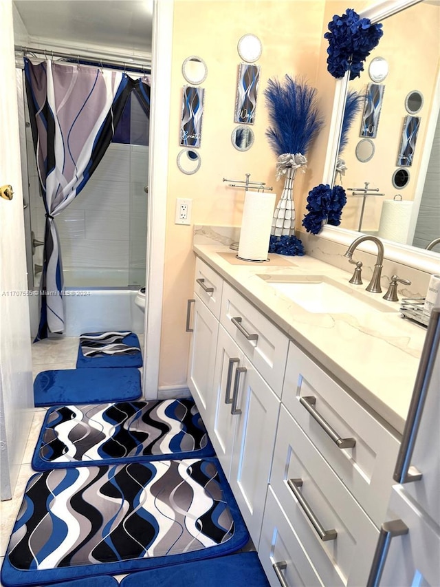 bathroom featuring tile patterned floors, vanity, and shower / tub combo