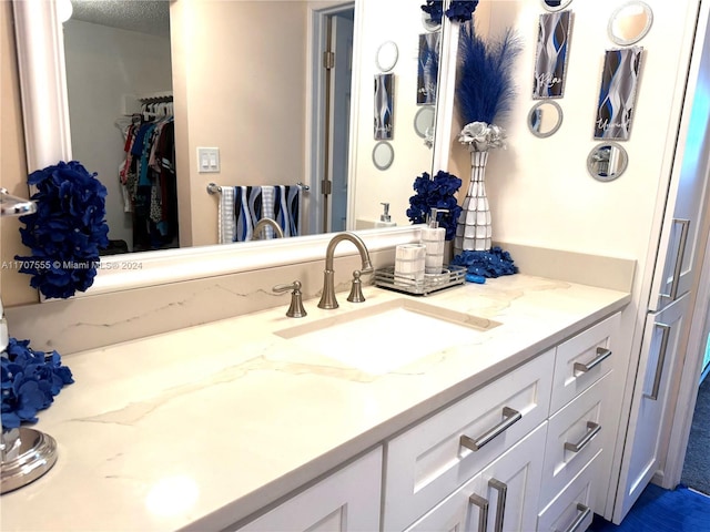 bathroom with vanity and a textured ceiling