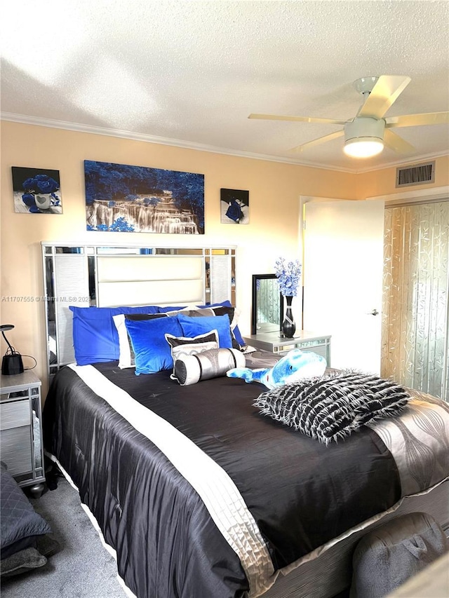 carpeted bedroom with ceiling fan, a textured ceiling, and ornamental molding