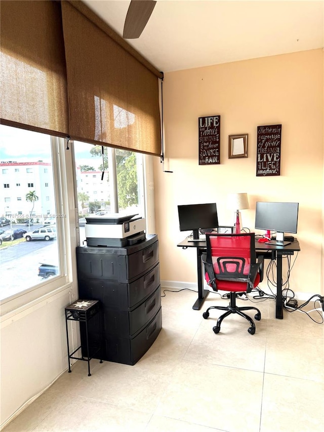 office area with light tile patterned floors and ceiling fan