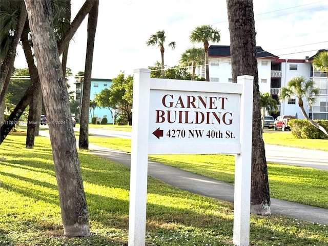 community / neighborhood sign featuring a yard