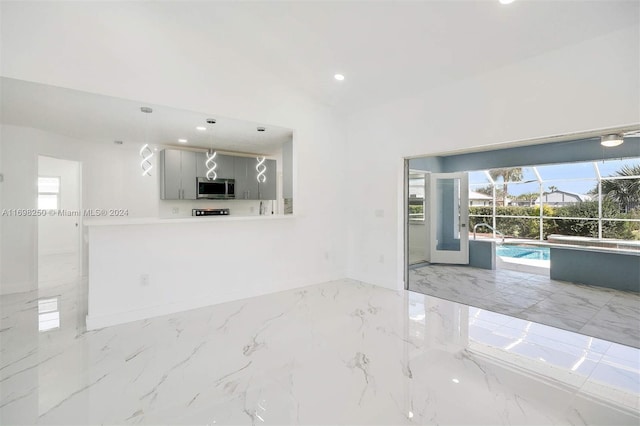 unfurnished room with lofted ceiling