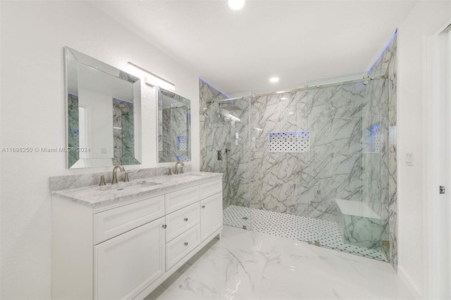 bathroom with a tile shower and vanity