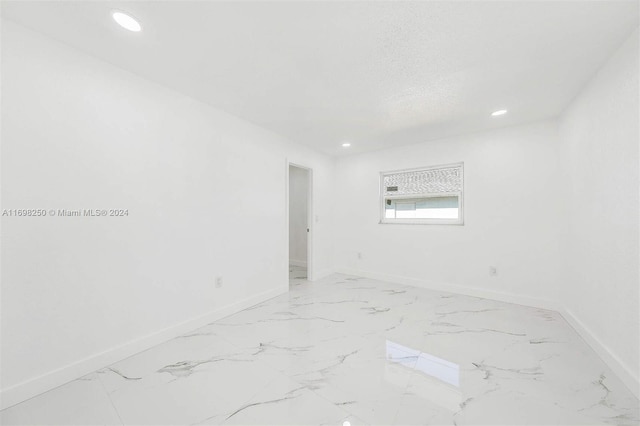 spare room with a textured ceiling