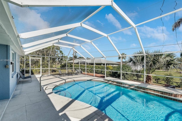 view of swimming pool with a lanai and a patio