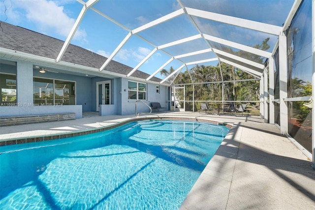 view of pool featuring a lanai, ceiling fan, and a patio area