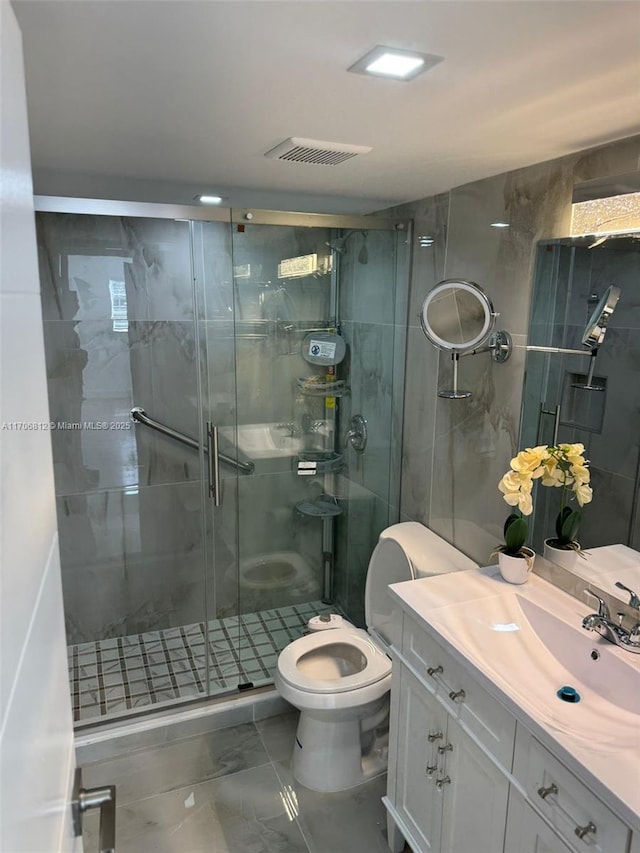 bathroom with an enclosed shower, vanity, and toilet