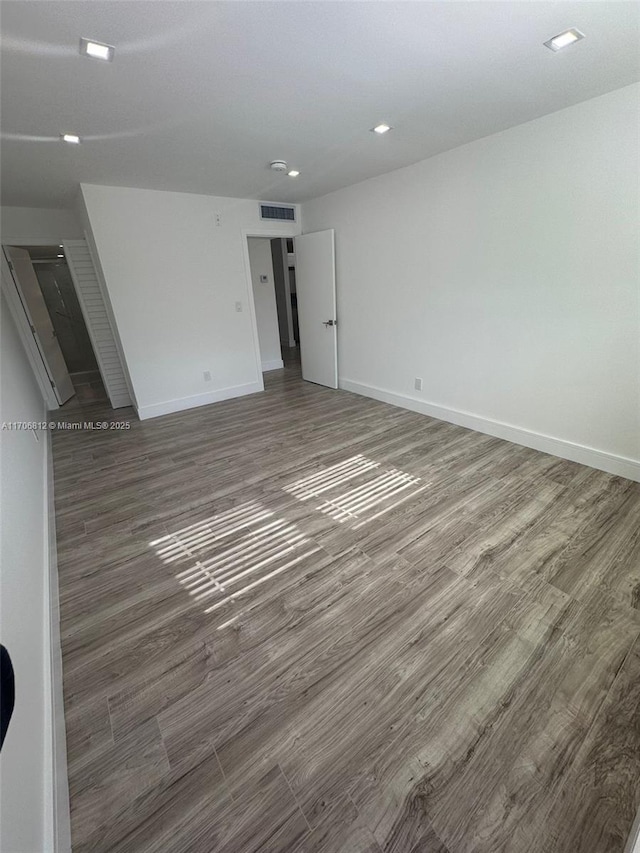 empty room with dark wood-type flooring