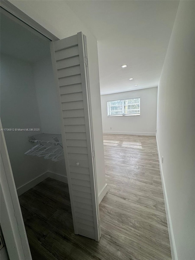 hall with hardwood / wood-style floors