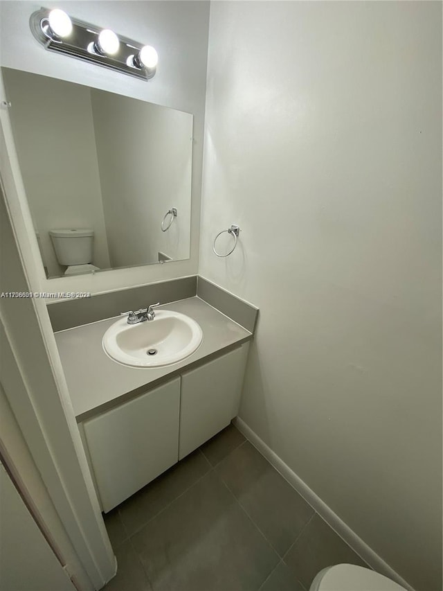 bathroom with tile patterned floors, vanity, and toilet