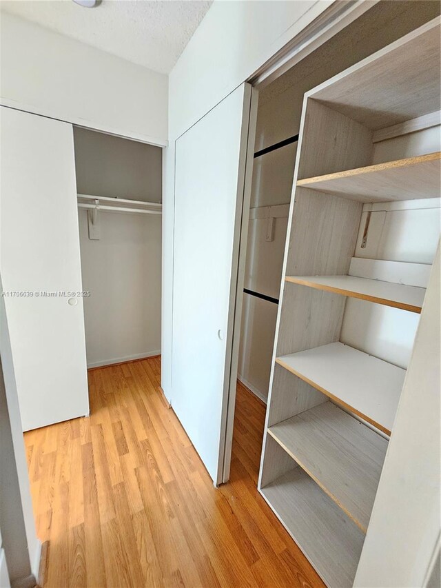 empty room with a textured ceiling and hardwood / wood-style flooring