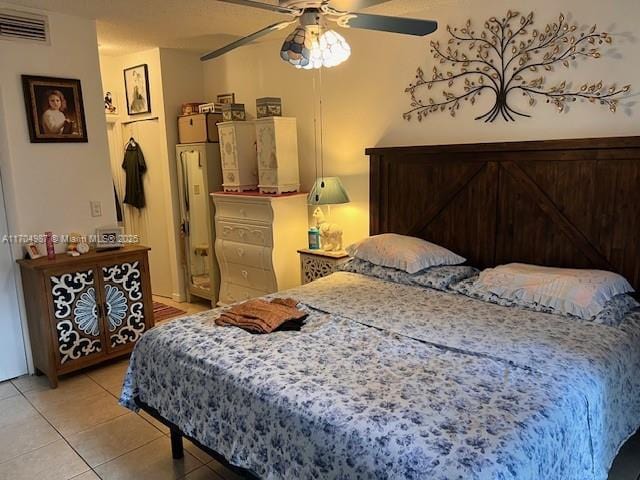 tiled bedroom with ceiling fan