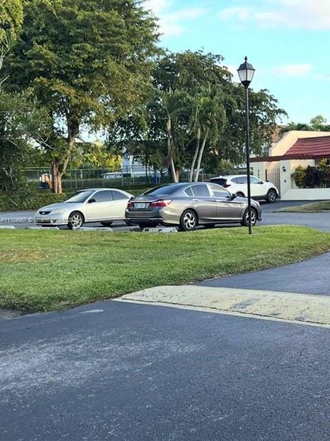 view of car parking featuring a yard