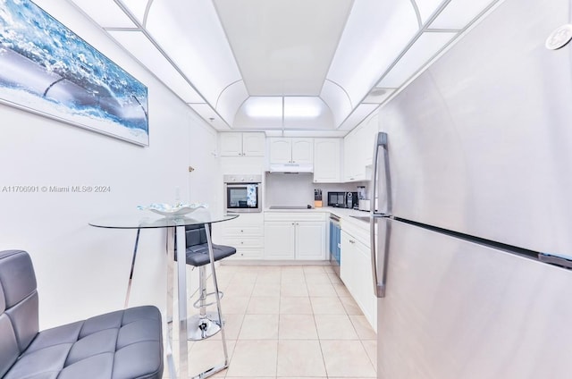 kitchen featuring black appliances, white cabinetry, and light tile patterned floors