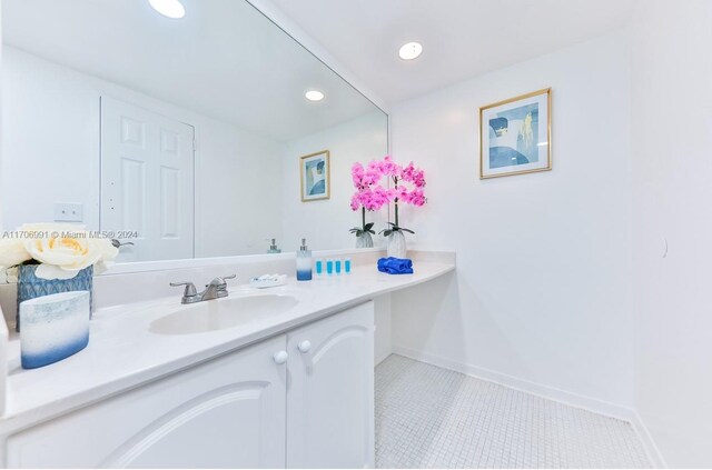 bathroom featuring tile patterned flooring and vanity