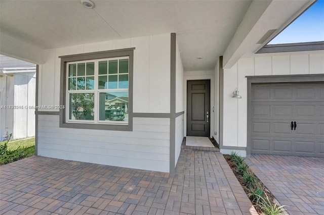 view of exterior entry featuring a garage