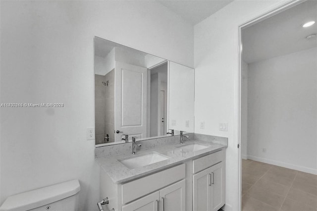 bathroom featuring tile patterned floors, vanity, and toilet