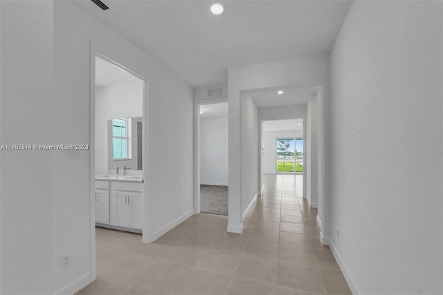 hall featuring light tile patterned flooring