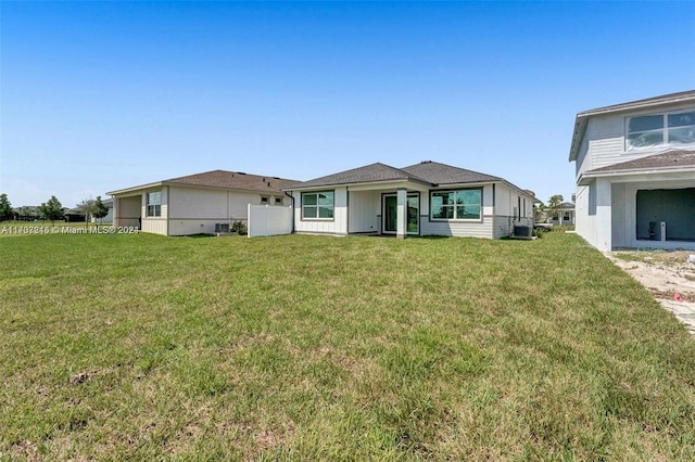 rear view of property featuring a yard