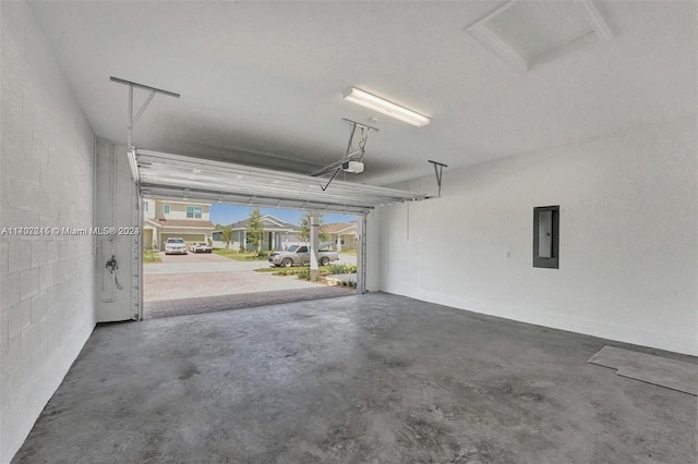 garage featuring electric panel and a garage door opener