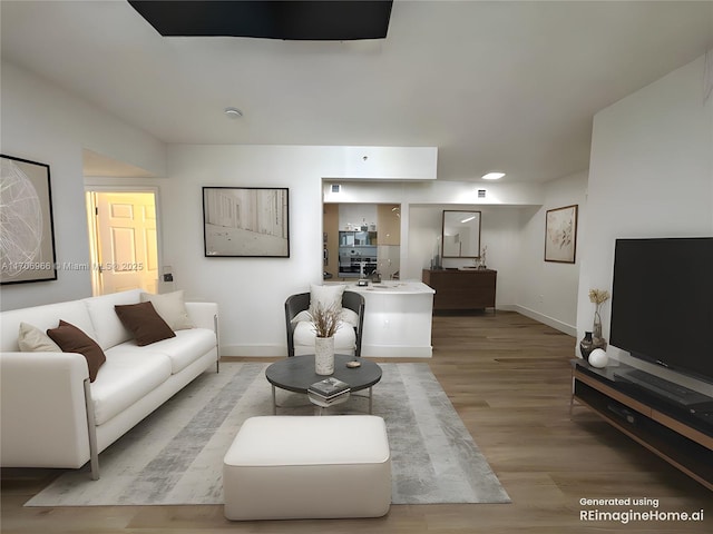living area with light wood finished floors and baseboards