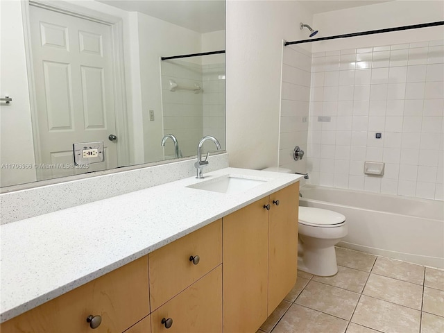 full bathroom featuring tile patterned floors, toilet, vanity, and tiled shower / bath