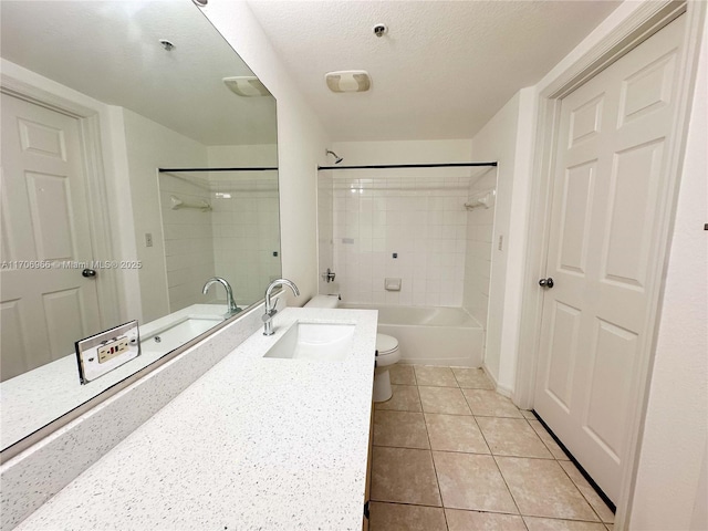 bathroom with toilet, a textured ceiling, tub / shower combination, vanity, and tile patterned flooring