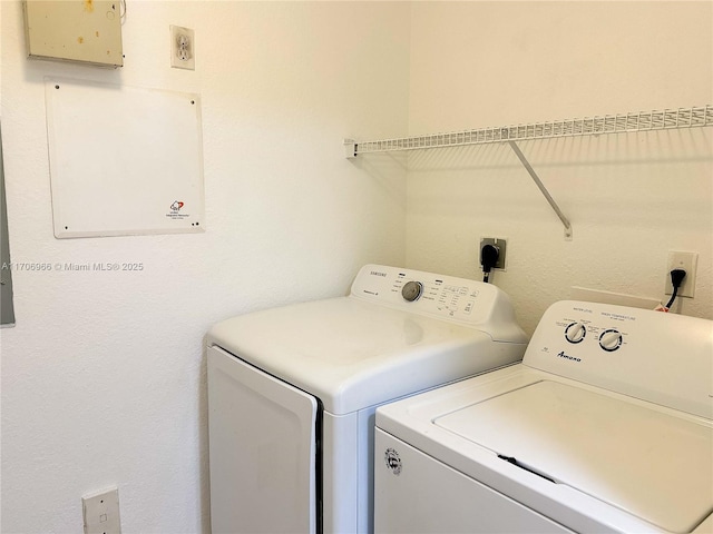 washroom featuring laundry area and separate washer and dryer