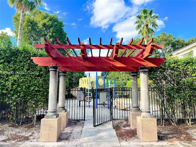view of home's community with fence, playground community, and a pergola