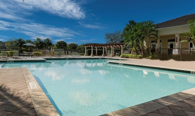 pool featuring a pergola, a patio, and fence